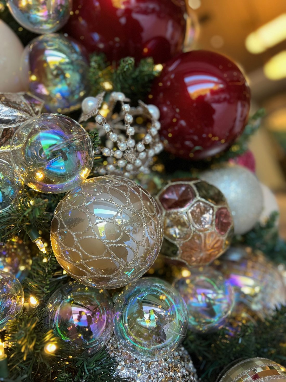 Red, gold and crystal ornaments clustered in a garland