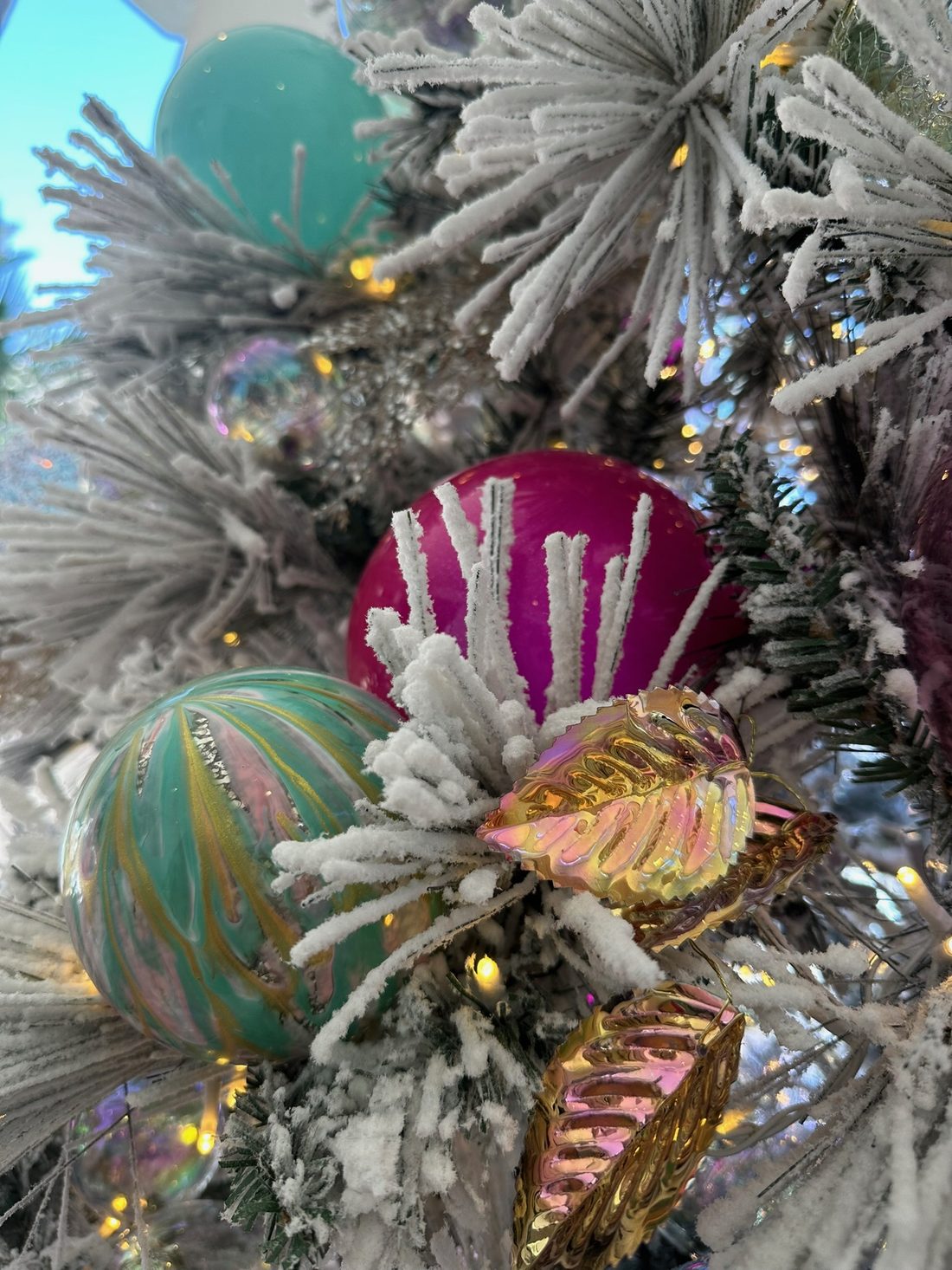 Flocked branches with teal and magenta ornaments