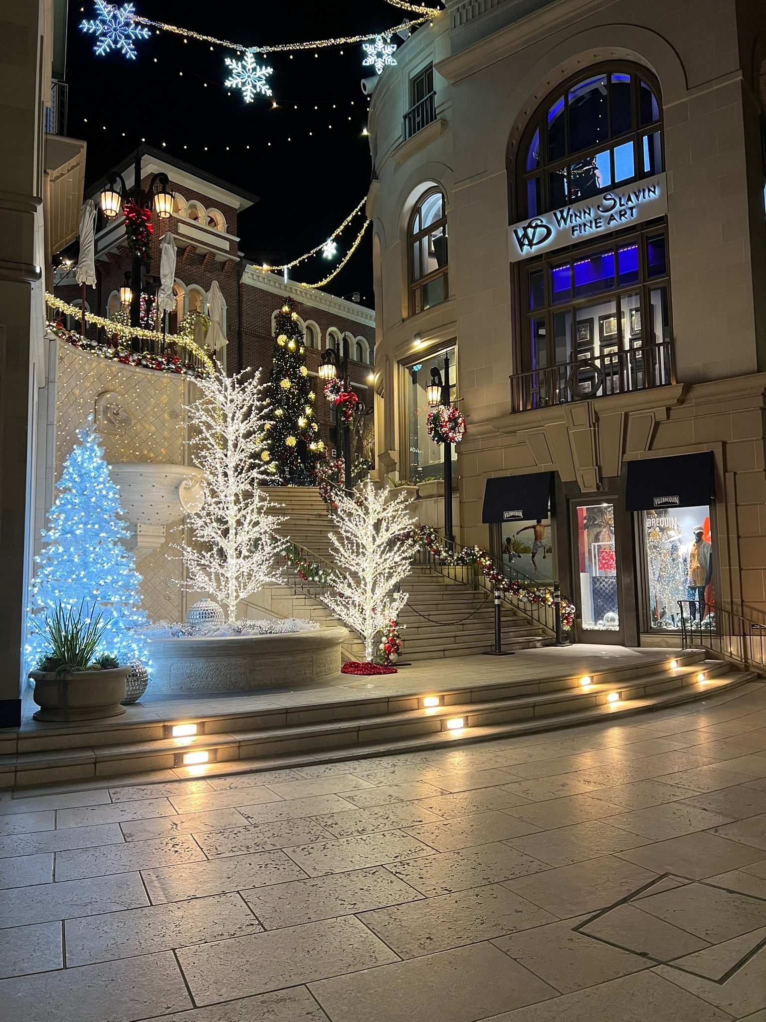 A Rodeo Drive storefront dressed in lights and white trees