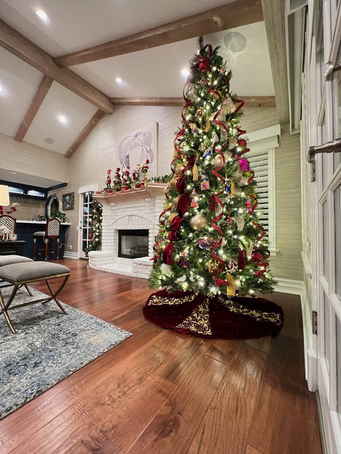 A tall tree beside a stone fireplace in a client's living room