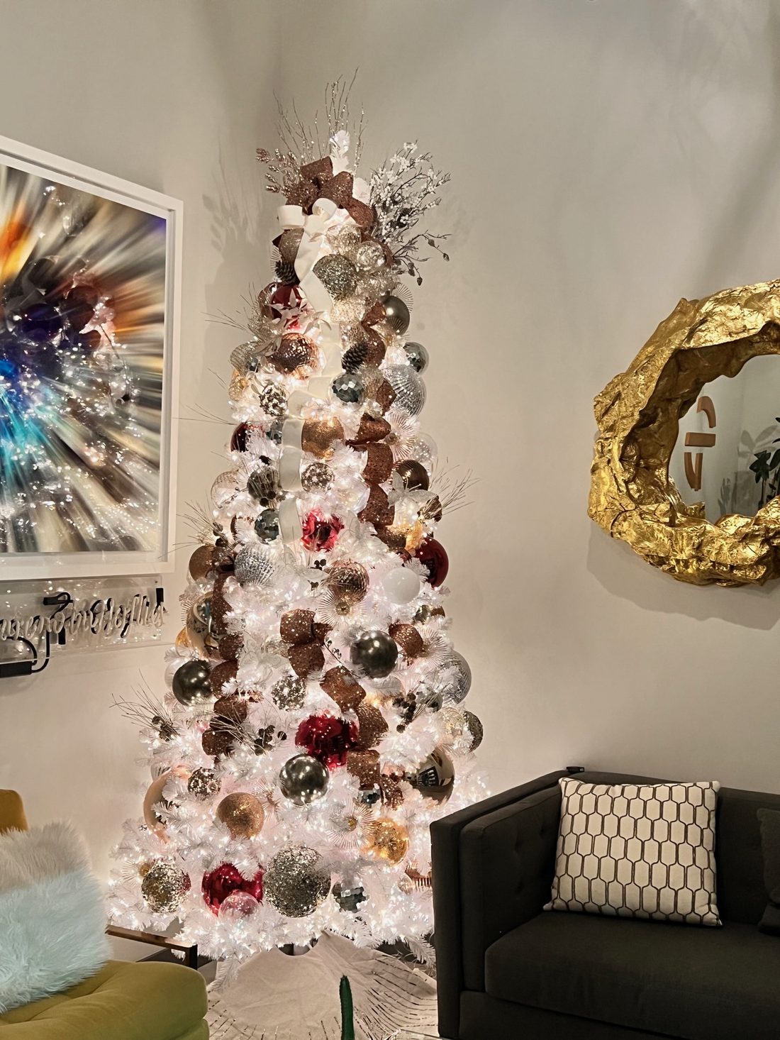 A white tree with burgundy and silver ornaments